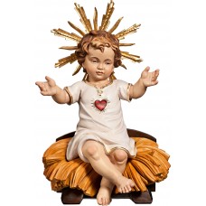 Niño Jesús vestido con Corazón sentado en cuna